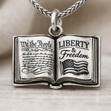 A school book with the constitution freedom peace necklace